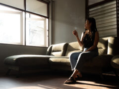 Woman smoking cannabis in an air-conditioned lounge at Leafers Cannabis and Lounge, Chiang Mai, Thailand.