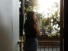 Woman smoking cannabis on the balcony of Leafers Cannabis and Lounge, Chiang Mai, Thailand.
