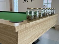 Green Family cannabis lounge in Pai, Mae Hong Son, with pool table and cannabis flower jars.
