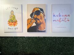 Wall art featuring Buddha, Snoop Dogg smoking, and 