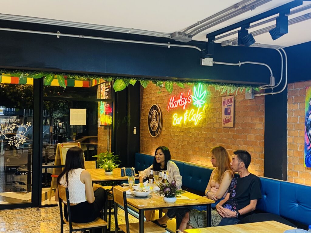 Four people seated at tables in 