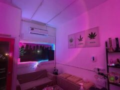 Interior of S’Weed Cannabis Shop, Ayutthaya, Thailand, showing a relax zone, Indica, Sativa, Hybrid strain art and smoking accessories.