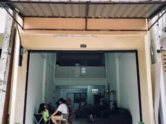 Exterior of ほじゅう hojū dispensary cafe in Khon Kaen, Thailand, showing people, plants, and open shopfront.
