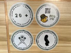 Stickers at Green Family dispensary, Pai, Thailand, with rules: 20+ to buy cannabis, must smoke inside, no pregnant customers.