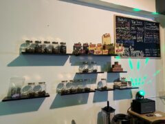 Interior of Green Family cannabis shop in Pai, Mae Hong Son, with cannabis flower, and a menu board.