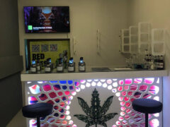 Interior of Smoky Bar dispensary in Pattaya, Thailand, showing cannabis leaf logo on bar and seating.