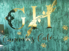 GH Cannabis Cafe sign in Hua Hin, Thailand, with gold lettering and cannabis leaf design on turquoise wall.