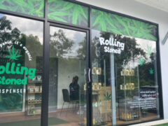 Exterior of Rolling Stoned Phuket dispensary in Chalong, Phuket, Thailand, showing shopfront and cannabis leaf designs.