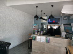 Interior of Dank Buds Pattaya in Muang Pattaya, a weed shop with seating, bar area, and TV.
