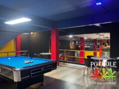 Interior of Pot Hole Cafe Bar Dispensary, Pattaya, Thailand, with pool table and logo. Cannabis and weed available.