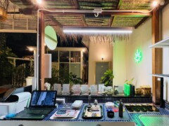 Inside SeaWeed Cannabis Store, Hua Hin, with cannabis display, neon sign, and accessories.