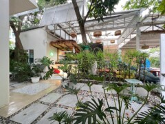 Exterior of SeaWeed Cannabis Store, a cafe-style weed shop in Hua Hin Soi 83, Thailand, with garden area.