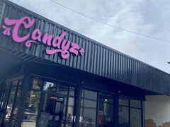Exterior of CANDYZ dispensary at 259 หนองหญ้าลาด, Kantharalak, Si Sa Ket, Thailand with pink logo and open sign.