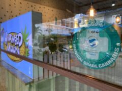 Harweed moon Bud Dispensary window, Huai Khwang, Bangkok. Medical grade cannabis certification & logo visible.