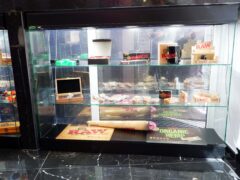 Glass display of RAW rolling papers and accessories at THC Bangkok in Khlong Toei.
