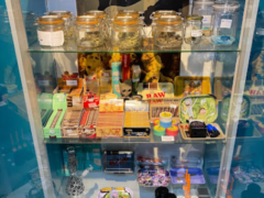 PJB Weed Aholic dispensary in Chiang Mai, Thailand, display case with cannabis flower, smoking accessories, and jars.
