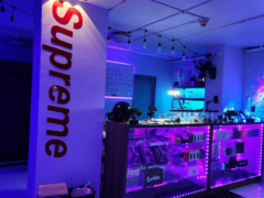 Interior of High Again cannabis shop in Ram Inthra, Bangkok, showcasing display cases, lighting, and smoking accessories.