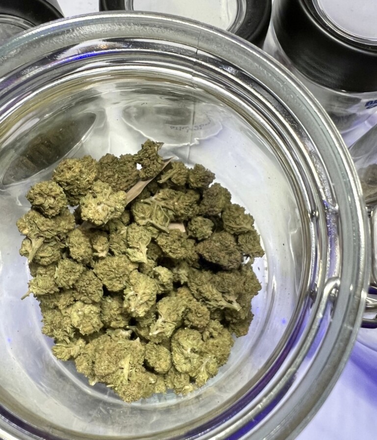 Jar of green cannabis buds.