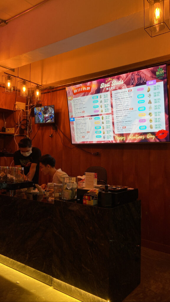 Two workers behind a counter below a 