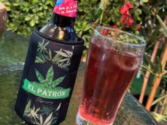 El Patron Dispensary in Hua Hin, Thailand, drinks; glass with red drink and a bottle in a holder with a cannabis leaf logo.