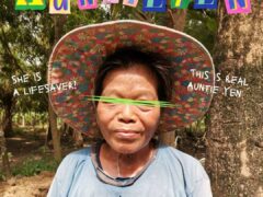 Auntie Yen of Auntie Yen & Co., Chiang Mai cannabis dispensary, wearing hat and smiling.