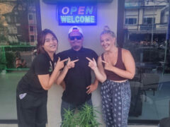 Smokey's Ao Nang cannabis shop exterior, Ao Nang, Krabi, Thailand. People pointing to cannabis plant.