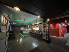 Interior of Sesh House cannabis shop in Krabi, Thailand. Counter with green LED lighting, seating areas visible.