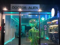 Exterior of Doctor Alien Shop with neon signs and inflatable alien in front. Bangkok, Thailand.