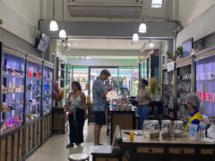 Inside Haze Buds Cannabis shop, Bangkok. Customers browsing cannabis flower and products.