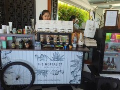 The Herbalist dispensary in Thong Krut, Koh Samui. Cannabis flower strains, edibles, and accessories visible.