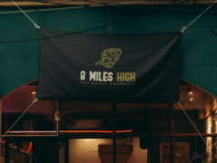 Sign for 8 Miles High cannabis shop in Nakhon Ratchasima, Thailand, selling cannabis flower and accessories.