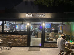 Exterior of Buds House Cafe cannabis shop in Don Mueang, Bangkok, showing entrance and storefront at night.