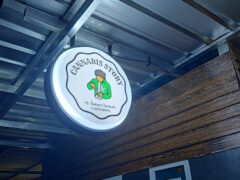 Cannabis Story sign at weed shop in Bang Samak, Chachoengsao, Thailand. Open 9 AM - 12 PM daily.