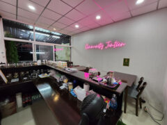 Interior of Community Cannabis, a weed shop in Pattaya, Thailand, showing cannabis flower selection and accessories.