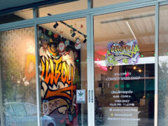 Cowboy Weed Shop ณ แม่โจ้ storefront in Chiang Mai, Thailand. Graffiti art and holiday decorations visible. Cannabis dispensary.