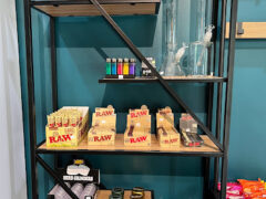 Shelves with bongs, lighters, papers, grinders at Fat Jim Premium Cannabis weed shop in Hua Hin, Thailand.
