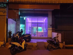 Exterior of Future Growth 420 cannabis shop in Bang Khun Thian, Bangkok, with purple neon glow at night.