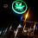 Green, illuminated marijuana leaf icon against a dark background, possibly a sign.