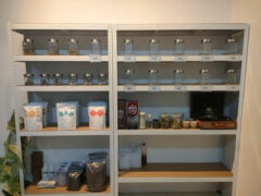 Shelves with cannabis flower in jars, smoking accessories at กัญชาอ่างทอง Happy week weed, Ang Thong, Thailand.