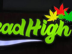 Head High Cafe sign with green, red, and yellow cannabis leaf accents in Lak Si, Bangkok.