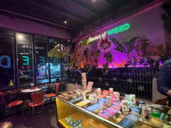 Interior of Heaven of Weed - SOHO Community, Sukhumvit 63, Bangkok, displaying cannabis flowers and accessories, neon sign.