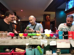 Customers examining cannabis flower at Helter Skelter Weed & Cannabis Dispensary, Bang Lamung District, Chon Buri, Thailand.
