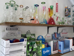 Interior of King Flowers Dispensary in Phaya Thai, Bangkok, showing various bongs and smoking accessories.