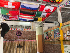 Interior of Mai Khao Weed, Phuket cannabis dispensary. Flags from around the world decorate the ceiling.