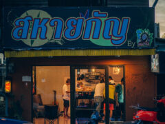 Exterior of Mr.Yll cannabis shop in Bang Phra, Trat, Thailand, with sign and people inside.