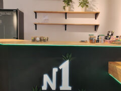 Interior of N1 Cannabis dispensary in Mae Nam, Ko Samui, showing the shop's logo, cannabis flower and accessories display.