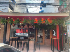 O2 Cannabis Club exterior, Petchkasem Rd, Hua Hin, Thailand. Weed shop with outdoor seating & hanging ferns.