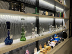 Interior of Oneounce.bkk cannabis shop in Bang Khae, Bangkok, showcasing bongs, smoking accessories, and cannabis-related products.