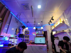 Interior of Pluk Pa Canabis Shop, Don Mueang, Bangkok, showing cannabis products, neon lights, and smoking accessories.