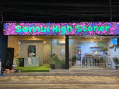 Exterior of Samui High Stoner cannabis shop in Tambon Bo Put, Koh Samui, Thailand, with neon sign at night.